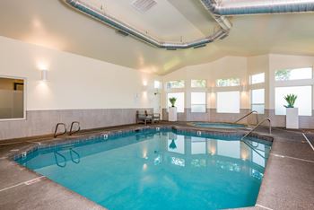a swimming pool in a hotel room with a blue pool